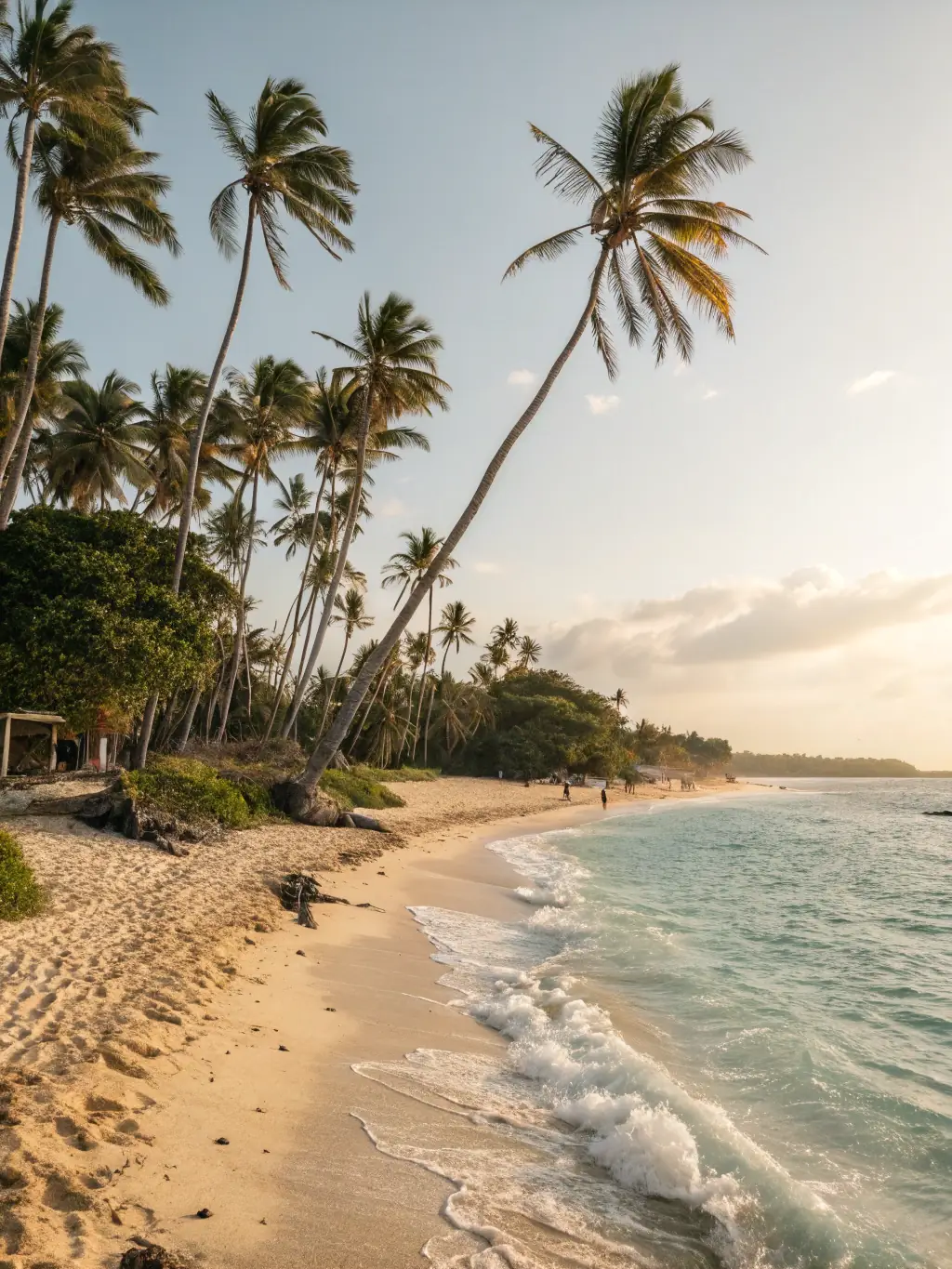 A serene image of Bai Dai Beach, featuring crystal-clear turquoise water, white sand, and palm trees, with a few people relaxing and swimming in the sea.