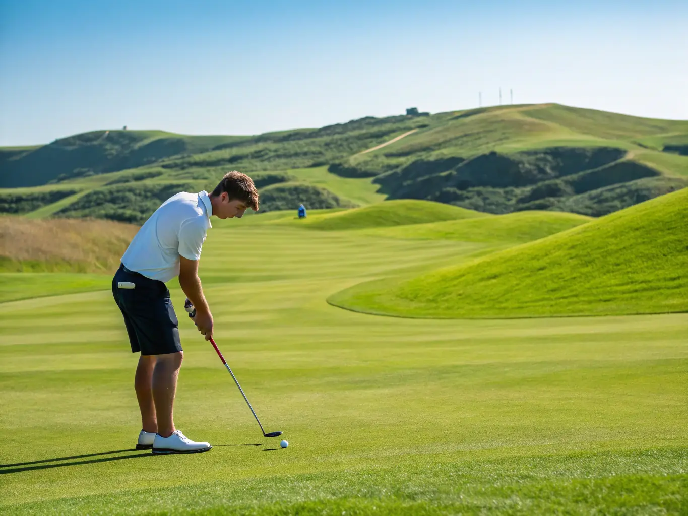 A golfer teeing off at Vinpearl Golf Nha Trang, with the ocean and surrounding islands visible in the background, highlighting the course's scenic beauty and premium golfing experience.